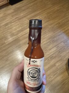 Apple Caraway hot sauce with melted wax seal